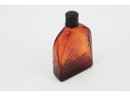 Buteleczka kosmetyczna z brązowego szkła, z napisem na spodzie: „NIVEA” i z płynną zawartością